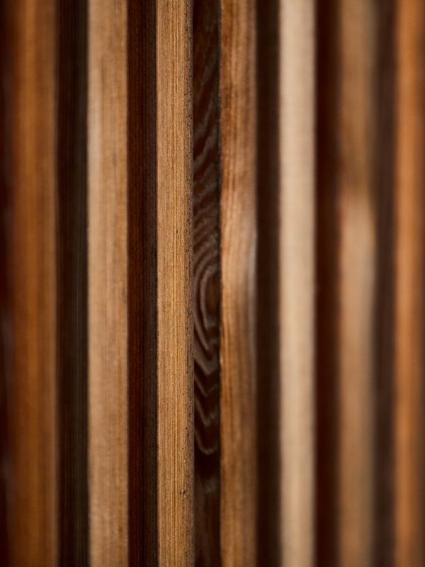 Close-up detail of vertical wooden slats showing natural wood grain textures.